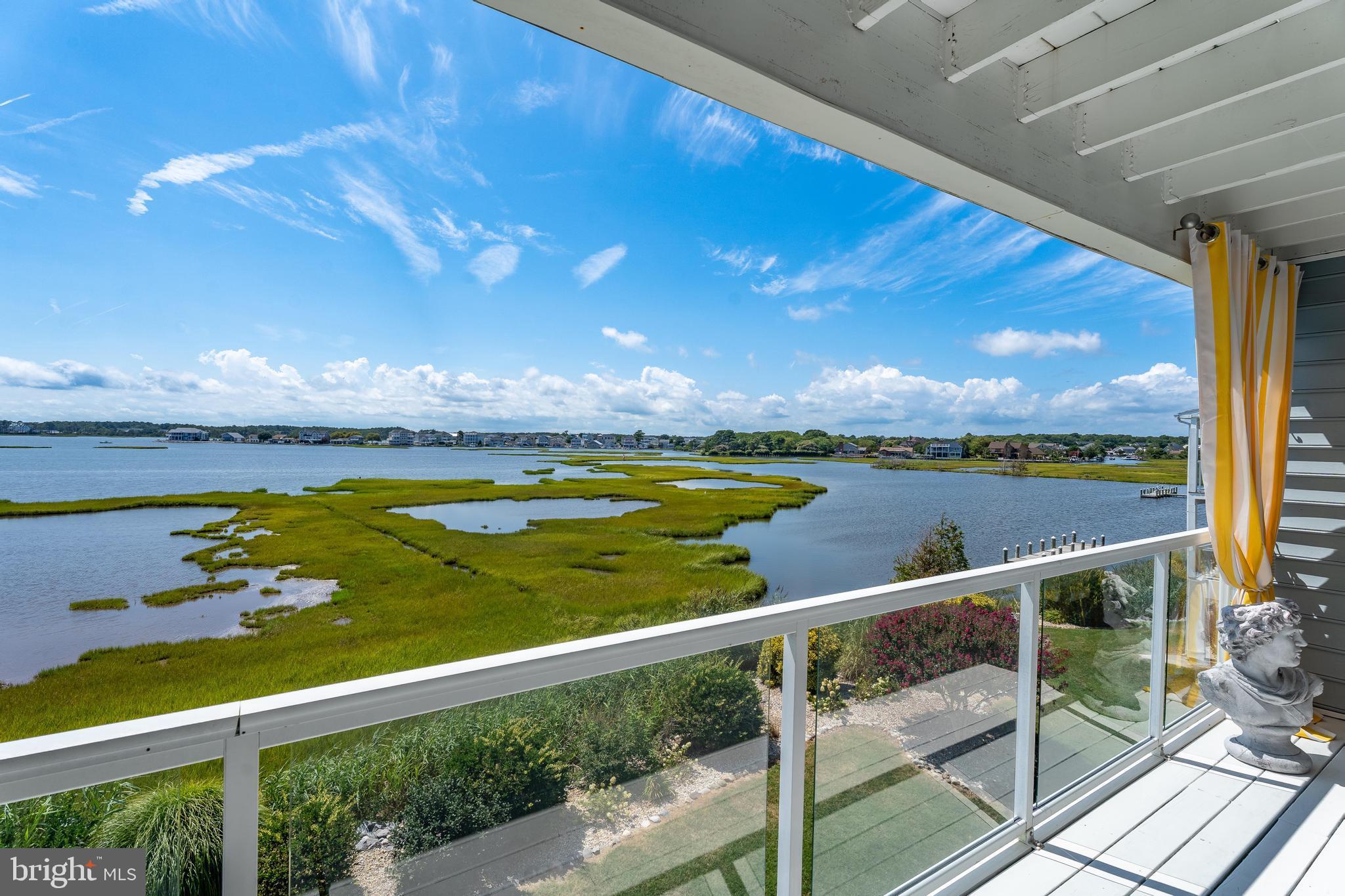 37304 Lighthouse Road, Unit 10 Selbyville, DE 19975 - Photo 3 of 40 a view of a lake from a balcony