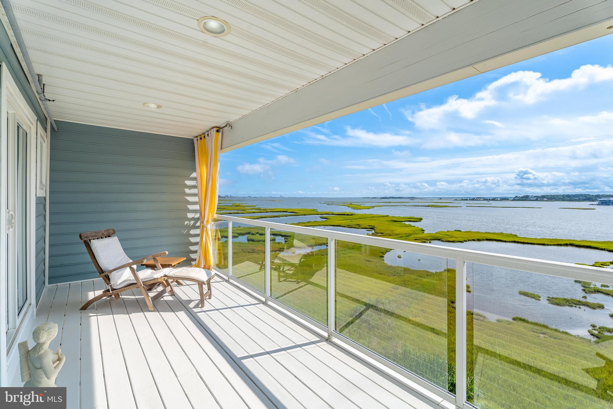 37304 Lighthouse Road, Unit 10 Selbyville, DE 19975 - Photo 10 of 40 a view of a balcony with chair and wooden floor