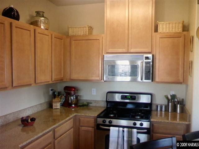 17000 Wedge Parkway, Unit 125 Reno, NV 89511 - Photo 3 of 7 a kitchen with stainless steel appliances granite countertop a stove a sink and a refrigerator