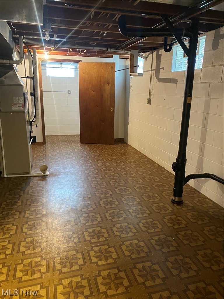 1518 Walnut Road Southwest Massillon, OH 44647 - Photo 21 of 26 Basement with dark parquet flooring and heating utilities