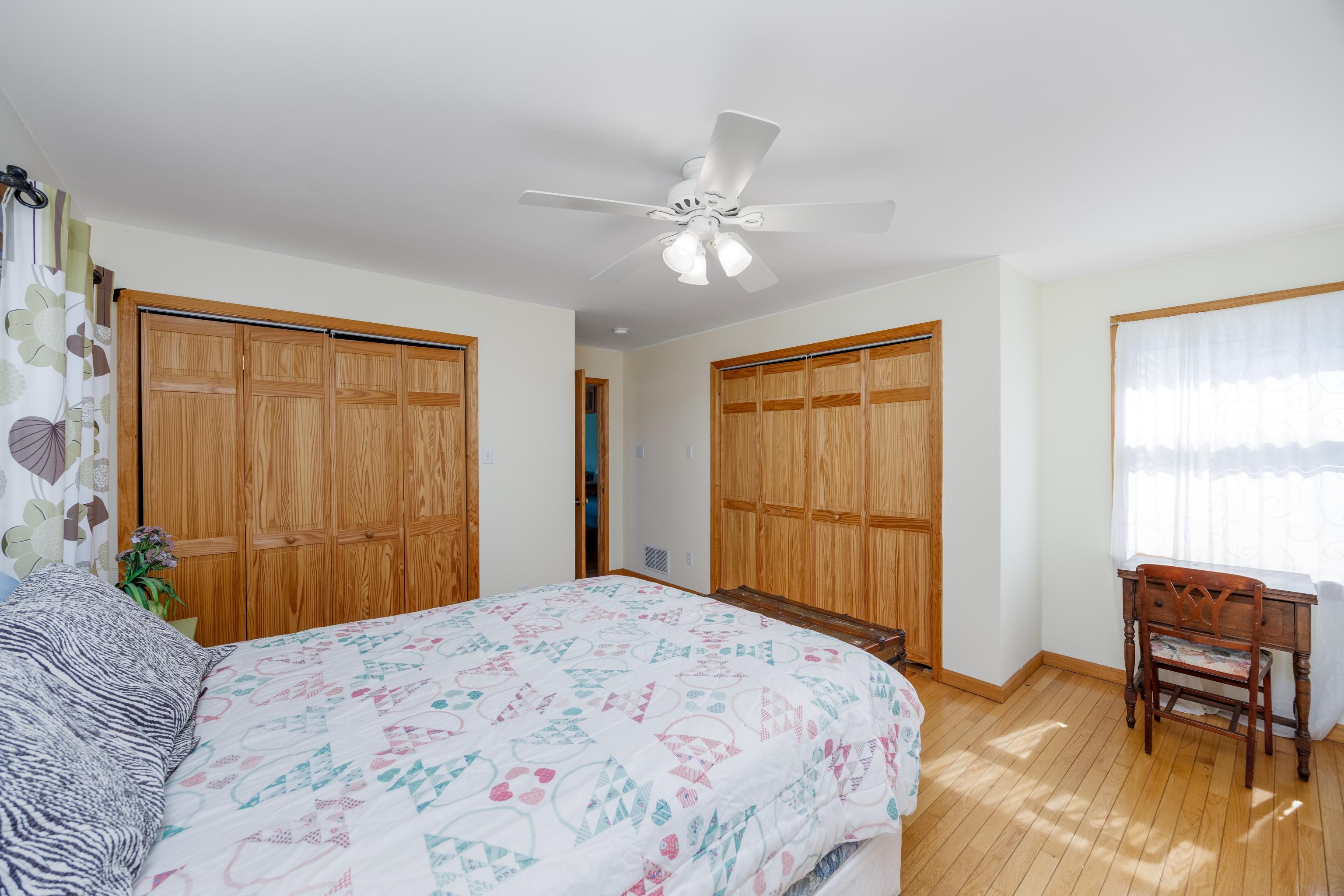 107 Avalon Road Cape May, NJ 08204 - Photo 11 of 25 a bedroom with a bed and a window with chair