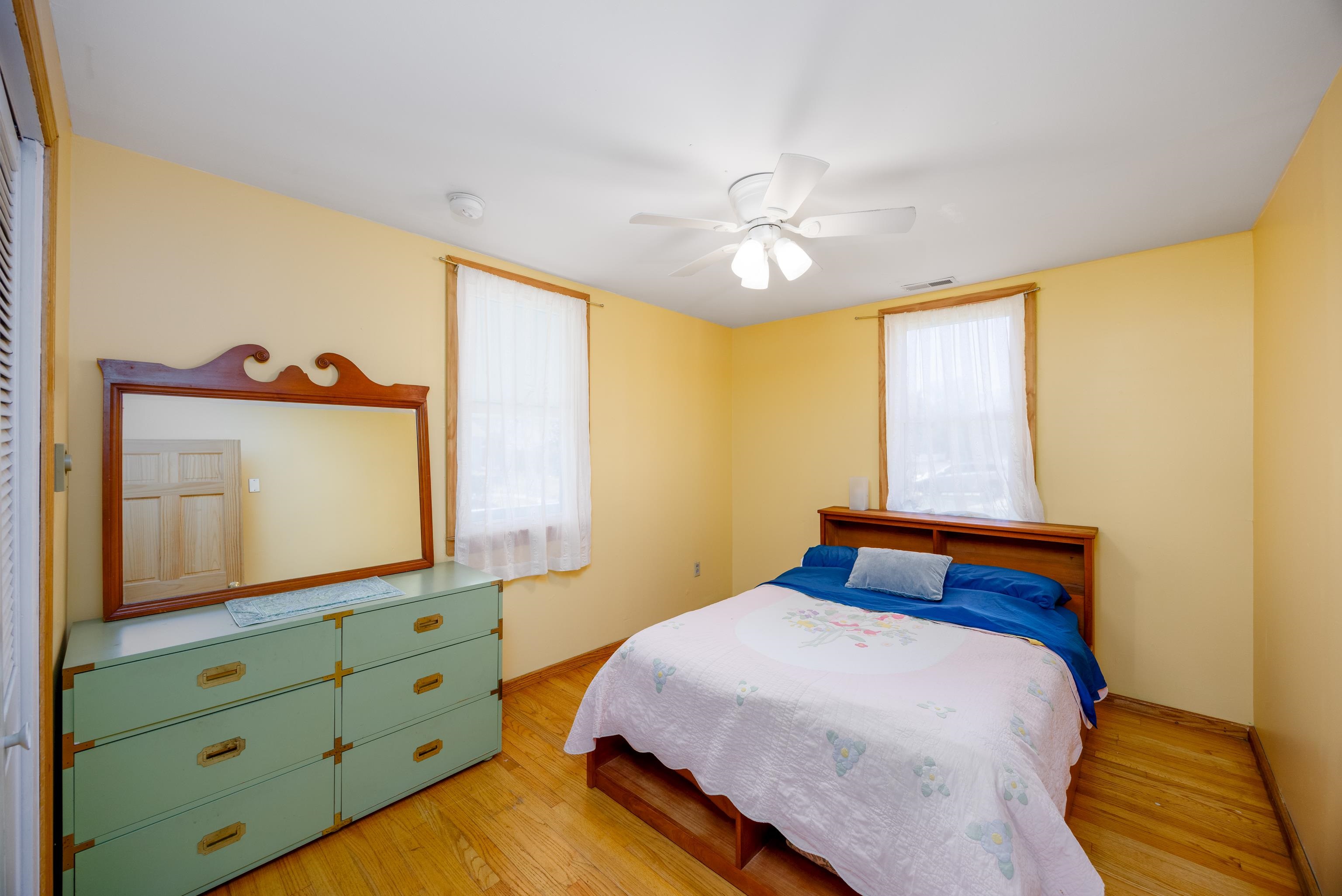 107 Avalon Road Cape May, NJ 08204 - Photo 14 of 25 a bedroom with a bed and a flat tv screen on dresser