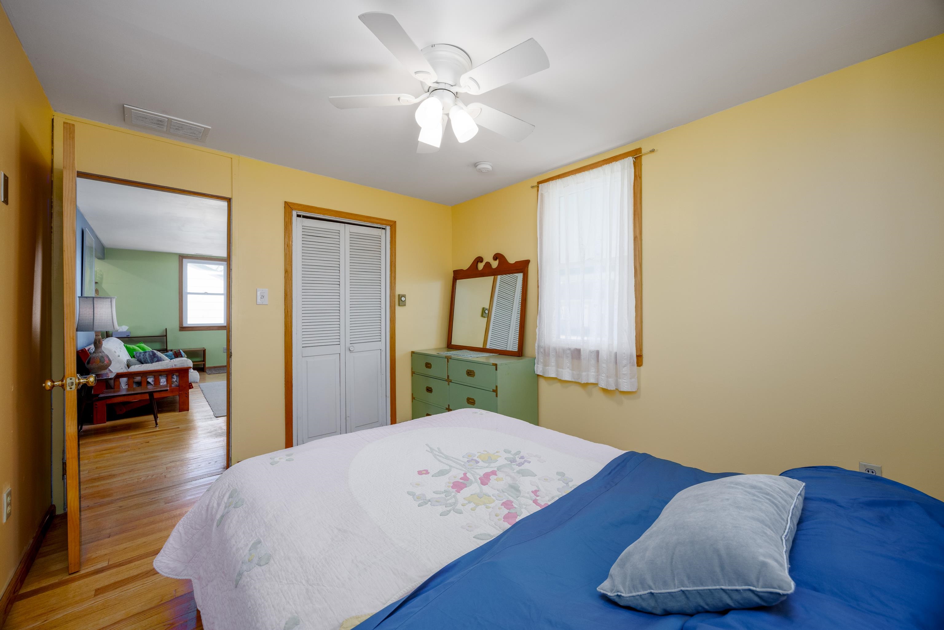 107 Avalon Road Cape May, NJ 08204 - Photo 15 of 25 a bedroom with a bed and a dresser with wooden floor