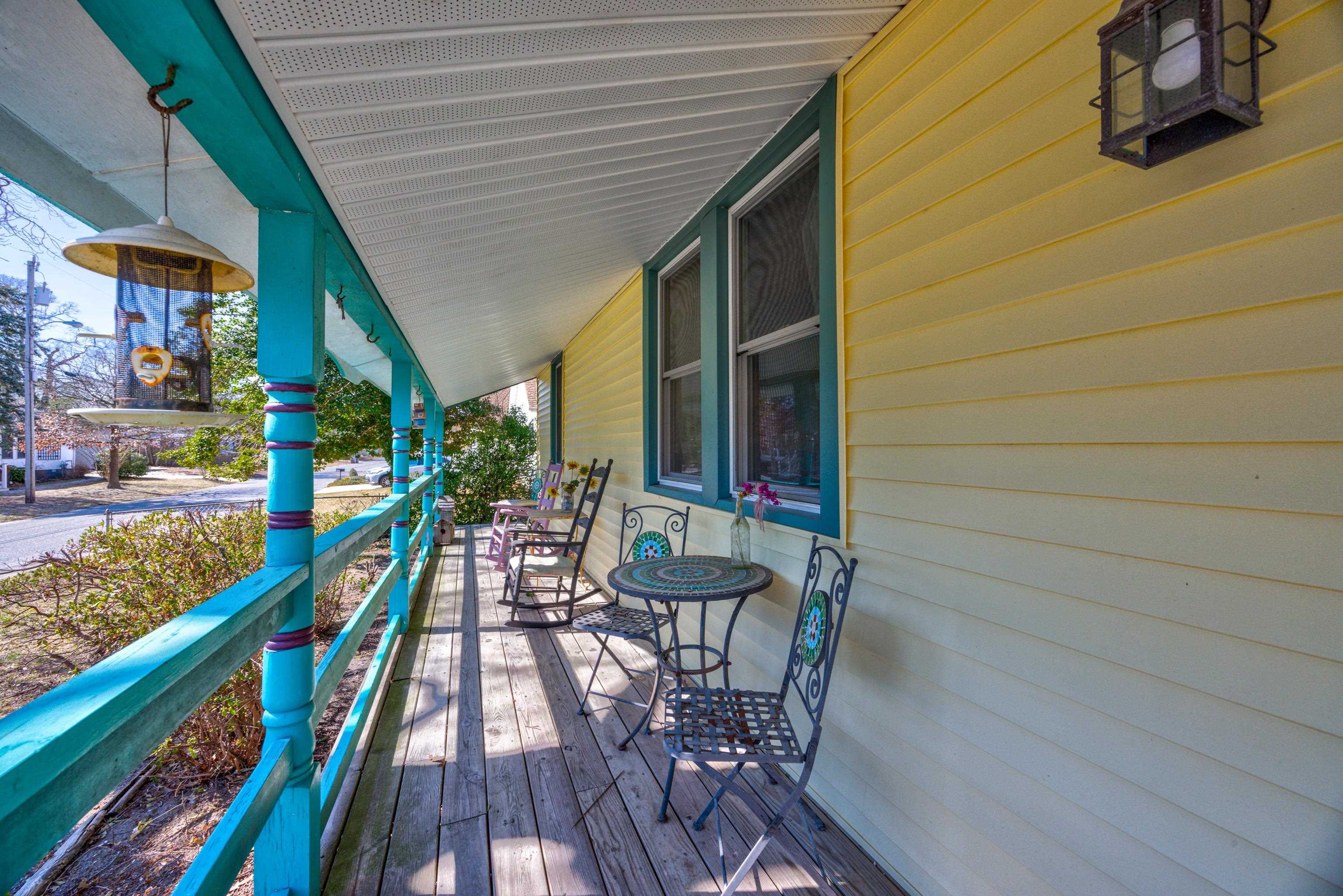 107 Avalon Road Cape May, NJ 08204 - Photo 3 of 25 a balcony with chairs and wooden floor