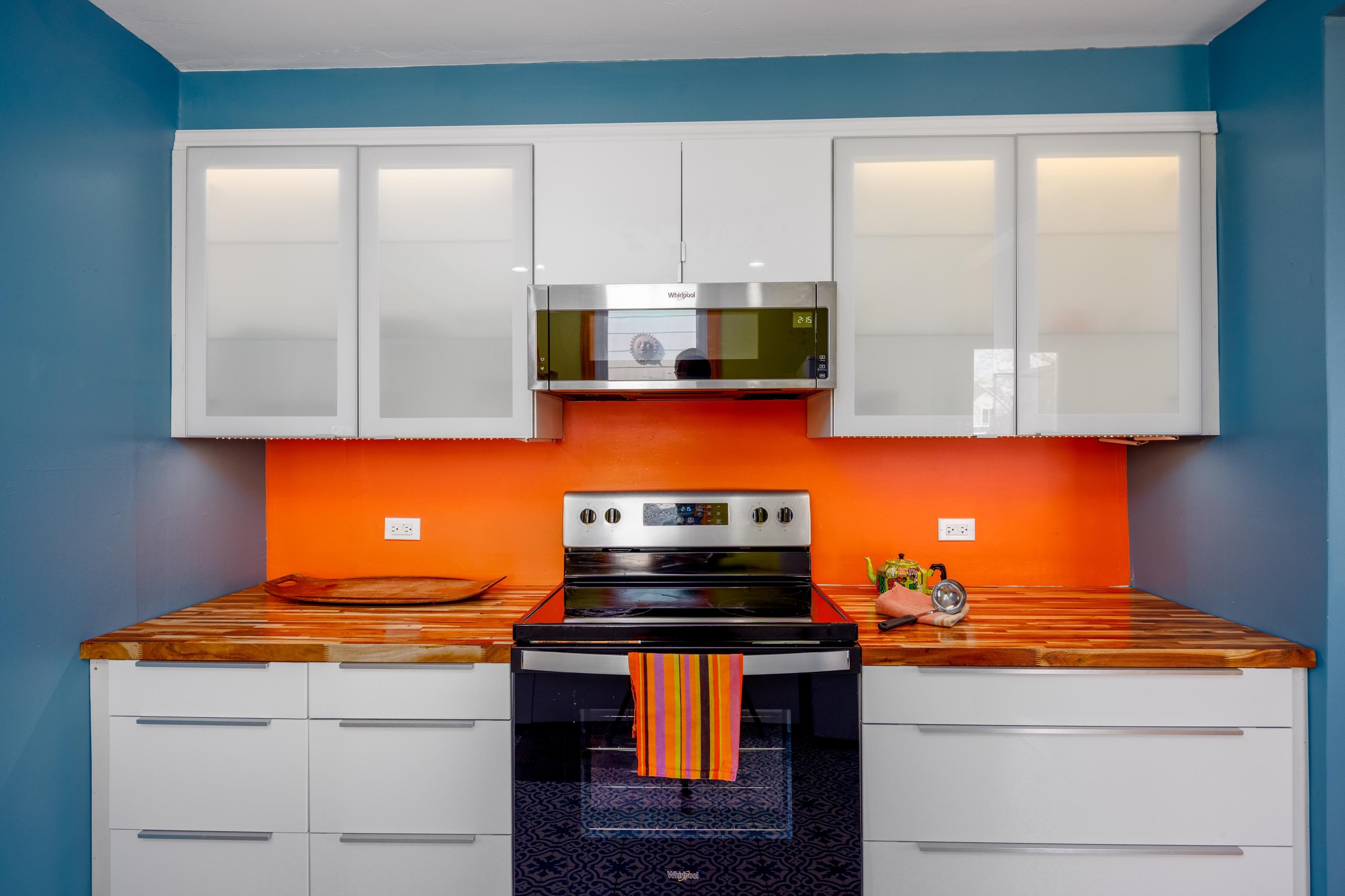 107 Avalon Road Cape May, NJ 08204 - Photo 6 of 25 a kitchen with stainless steel appliances granite countertop a stove and a microwave