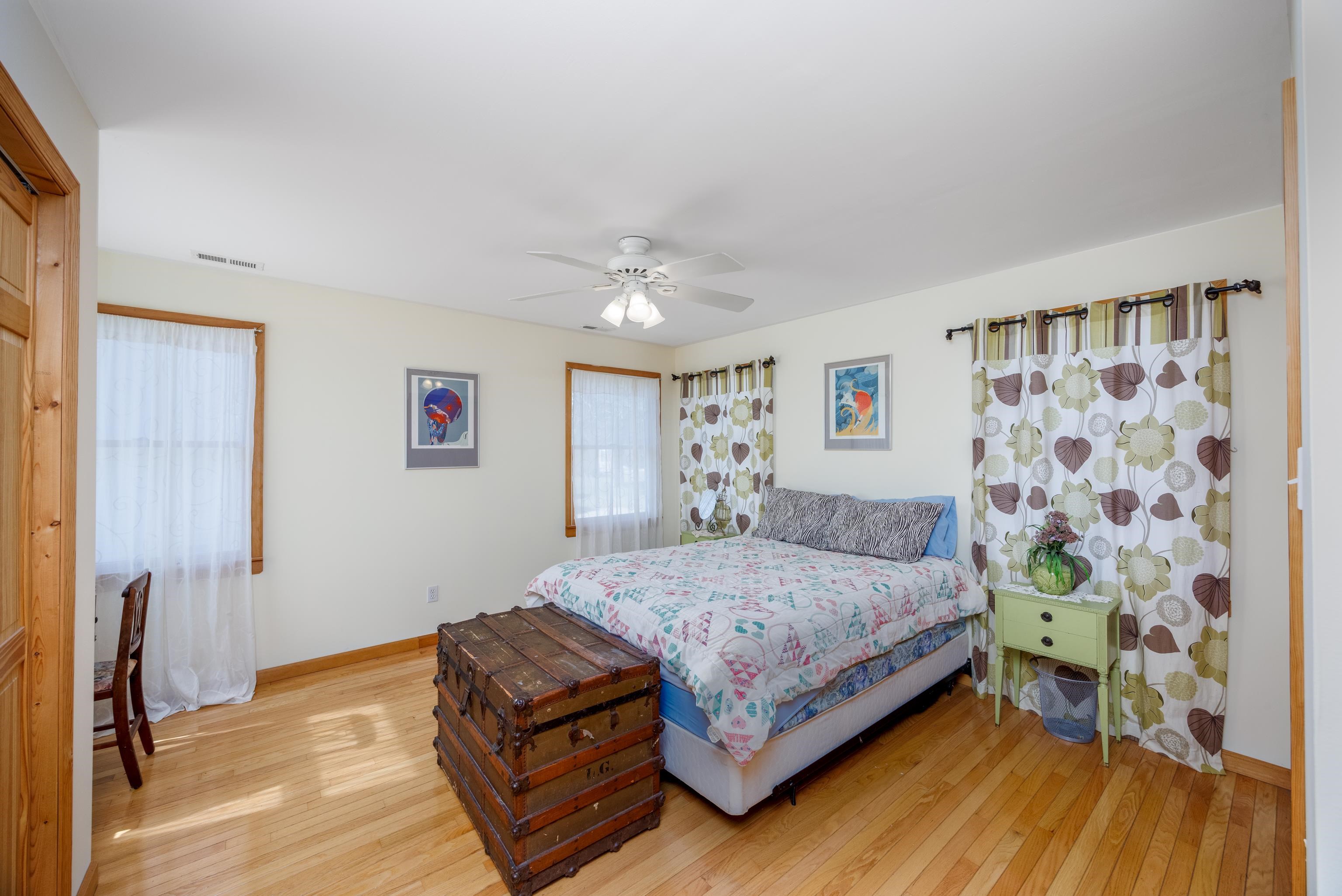 107 Avalon Road Cape May, NJ 08204 - Photo 10 of 25 a bedroom with a bed and a chandelier