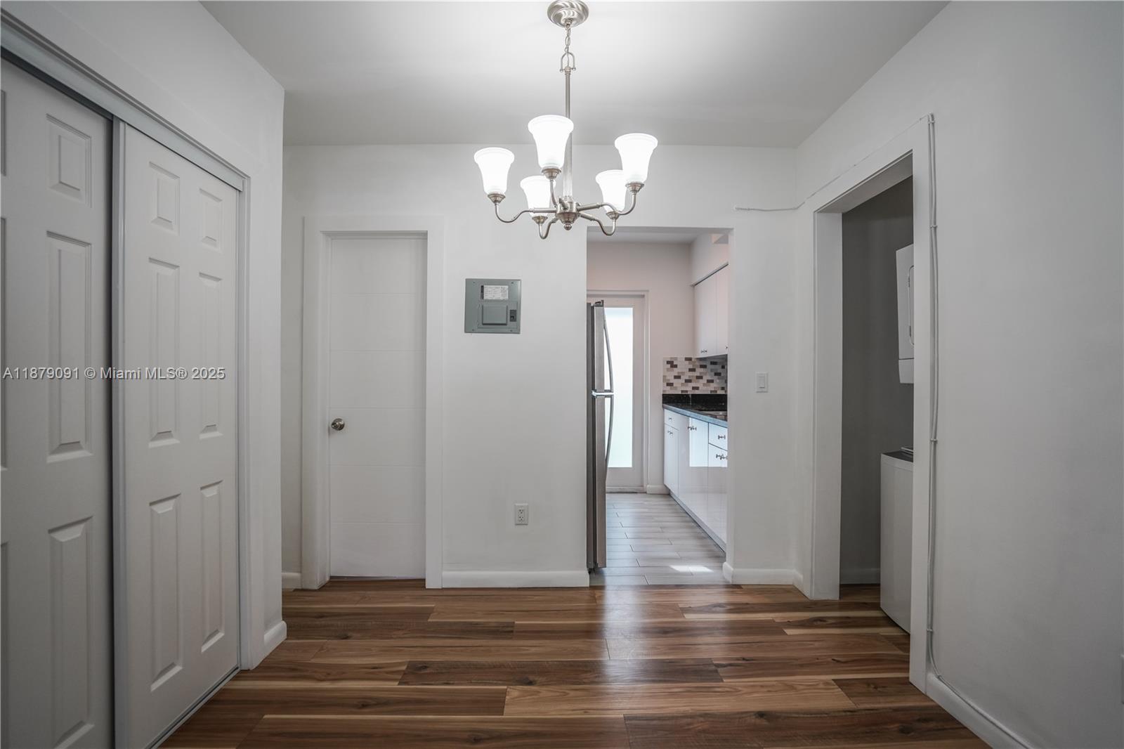 1120 Euclid Avenue, Unit 14 Miami Beach, FL 33139 - Photo 4 of 9 a view of an empty room with wooden floor and a window