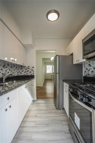 a kitchen with stainless steel appliances a refrigerator stove and sink