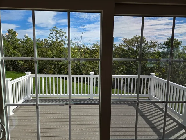 a view of a balcony with wooden floor