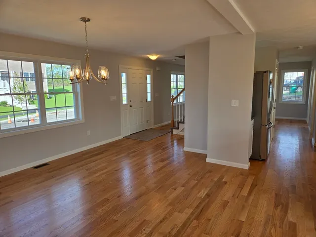 a view of a room with wooden floor and window