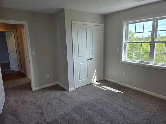 an empty room with windows and closet