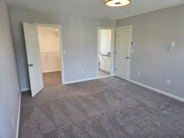 a view of an empty room with a bathroom