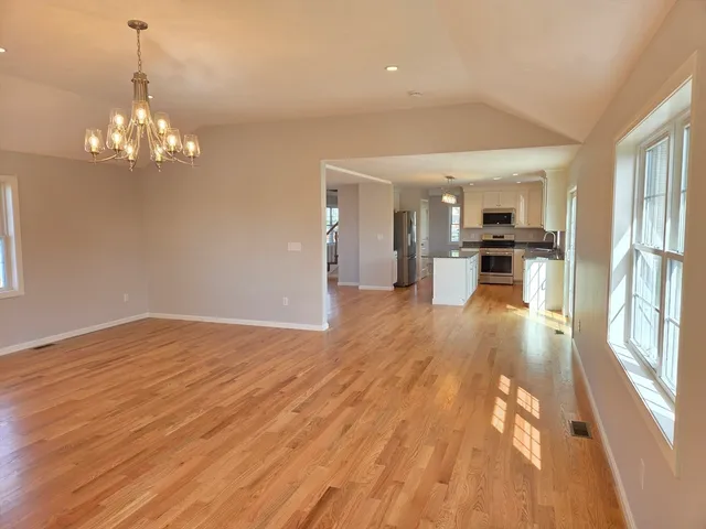 a view of a kitchen with stove and wooden floor
