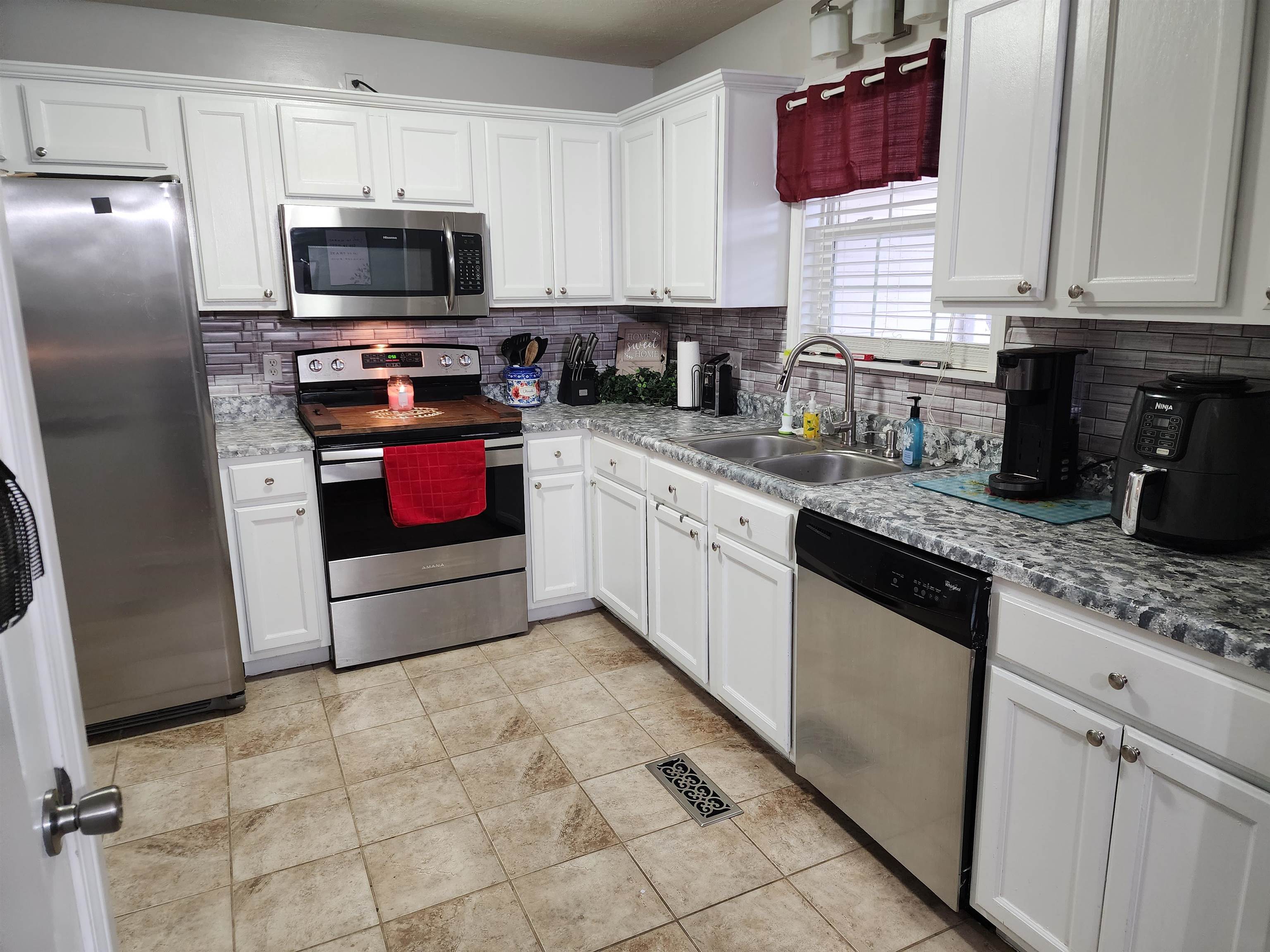 2316 Edith-Nankipoo Road Ripley, TN 38063 - Photo 5 of 12 a kitchen with stainless steel appliances granite countertop a sink and a stove