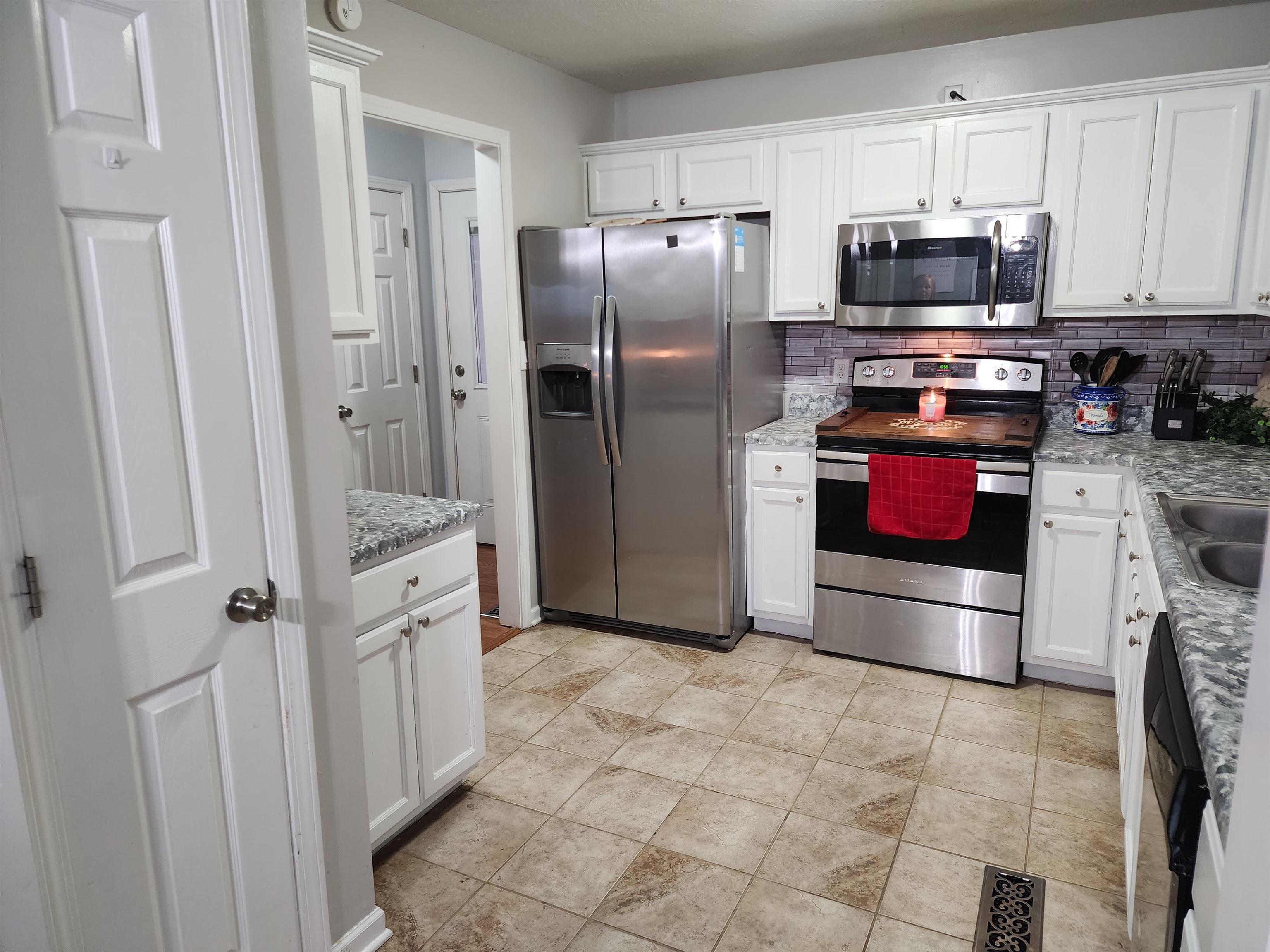 2316 Edith-Nankipoo Road Ripley, TN 38063 - Photo 6 of 12 a kitchen with stainless steel appliances granite countertop a refrigerator and a stove