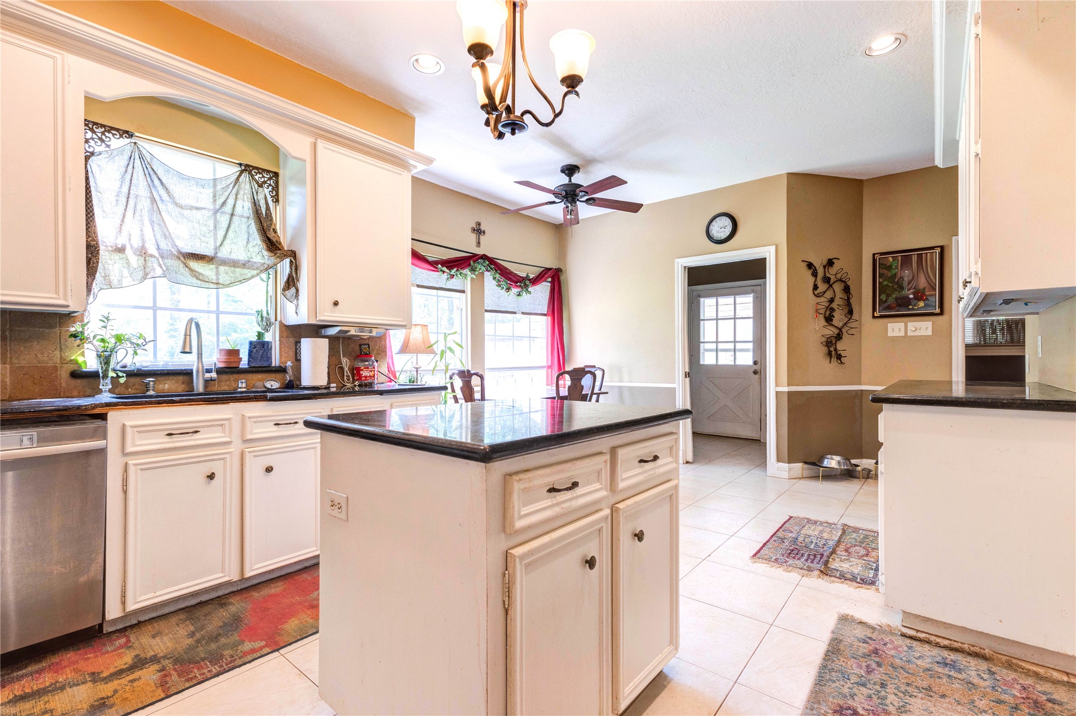 32037 Dobbin-Huffsmith Road Magnolia, TX 77354 - Photo 11 of 49 a kitchen with stainless steel appliances granite countertop a sink cabinets and wooden floor