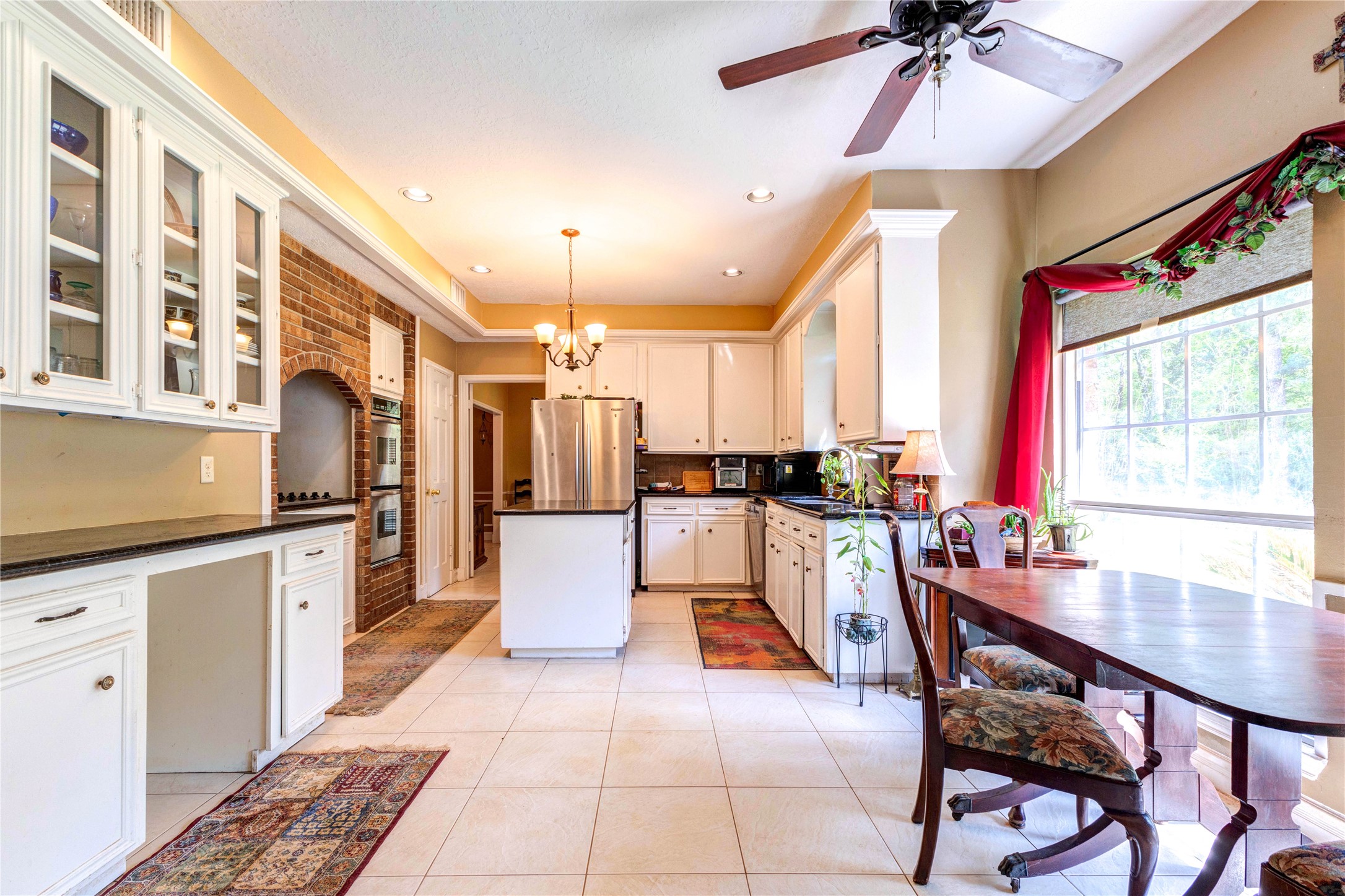 32037 Dobbin-Huffsmith Road Magnolia, TX 77354 - Photo 13 of 49 a large kitchen with a table and chairs