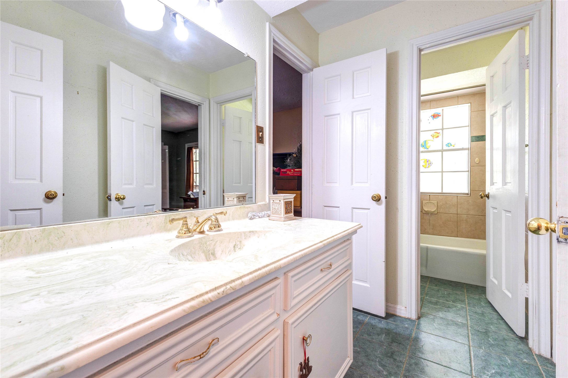 32037 Dobbin-Huffsmith Road Magnolia, TX 77354 - Photo 35 of 49 a bathroom with a granite countertop sink and a mirror