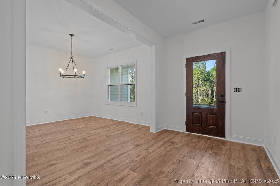 150 Hickory Pointer Way Cameron, NC 28326 - Photo 24 of 50 a view of empty room with wooden floor ceiling fan and window