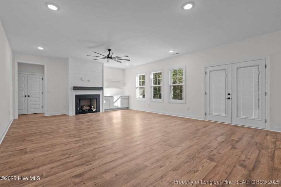 150 Hickory Pointer Way Cameron, NC 28326 - Photo 27 of 50 a view of empty room with wooden floor and fireplace