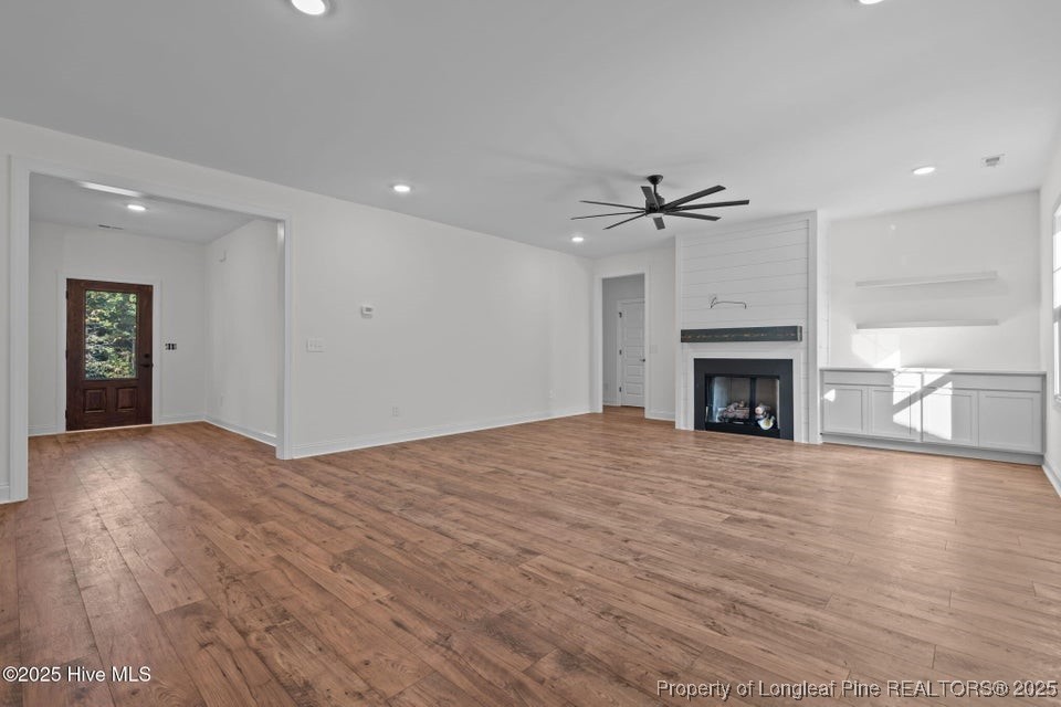 150 Hickory Pointer Way Cameron, NC 28326 - Photo 29 of 50 a view of empty room with wooden floor and fireplace