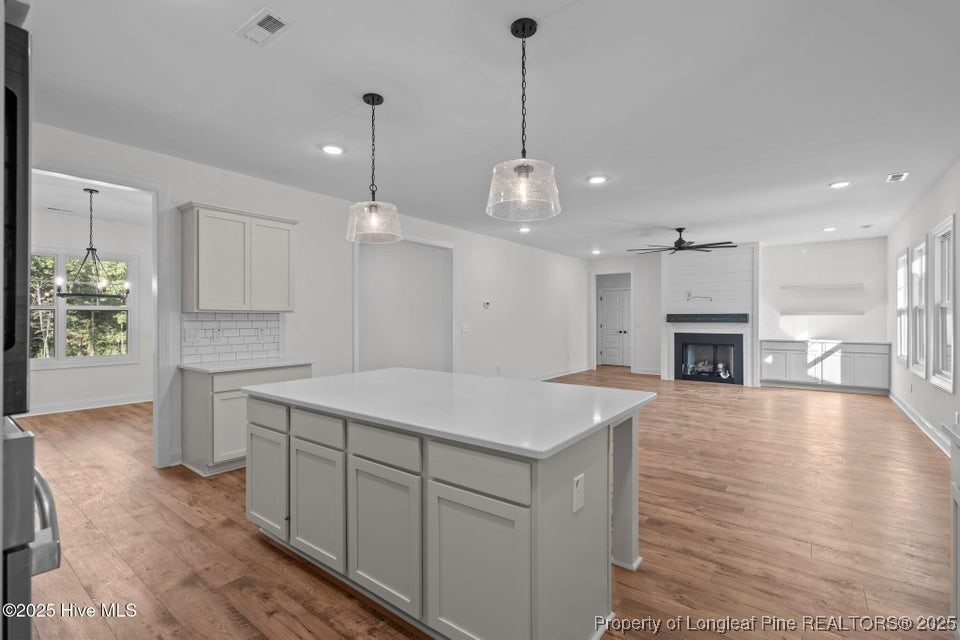 150 Hickory Pointer Way Cameron, NC 28326 - Photo 33 of 50 a large kitchen with kitchen island a stove a sink a center island a table and chairs