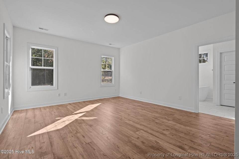 150 Hickory Pointer Way Cameron, NC 28326 - Photo 38 of 50 an empty room with wooden floor and windows