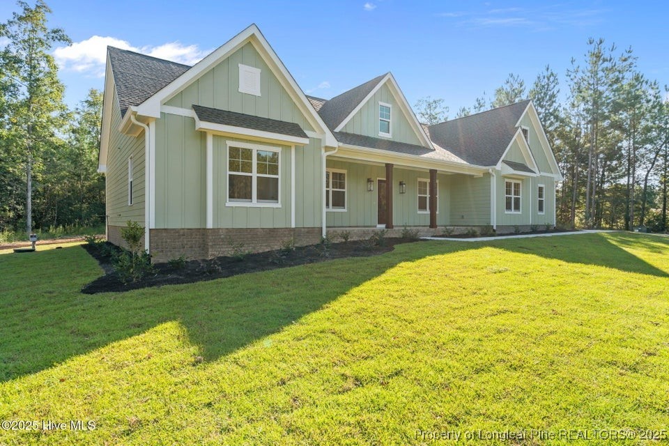 150 Hickory Pointer Way Cameron, NC 28326 - Photo 46 of 50 a front view of a house with a garden and trees