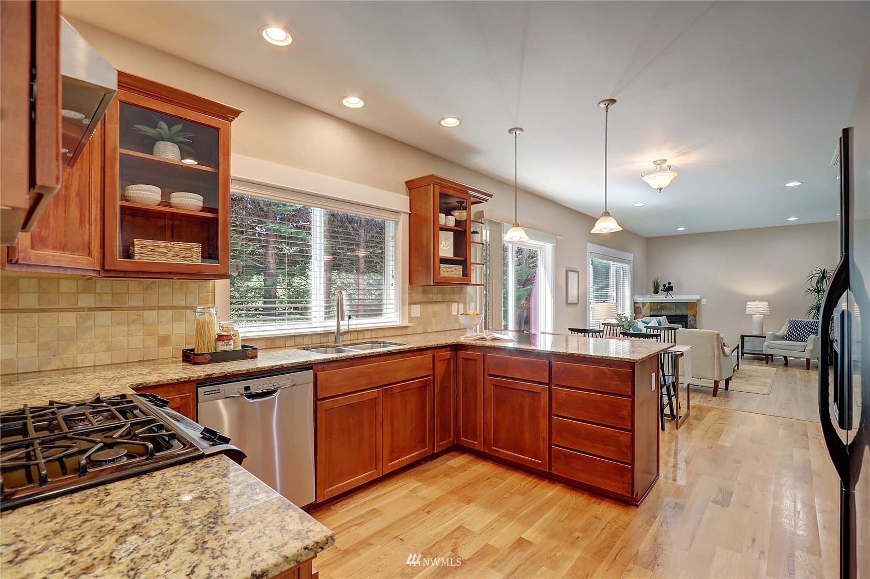 16 228th Street Southeast Bothell, WA 98021 - Photo 11 of 26 a kitchen with stainless steel appliances granite countertop sink stove and wooden cabinets