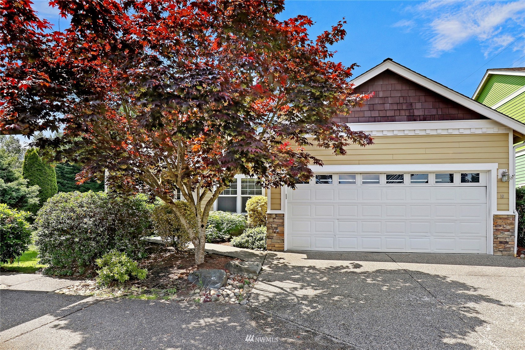 16 228th Street Southeast Bothell, WA 98021 - Photo 4 of 26 a front view of a house with a yard and garage