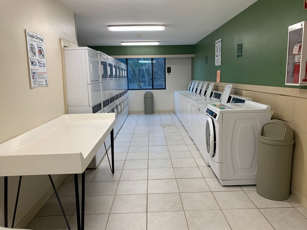 1500 Worcester Road, Unit 621 Framingham, MA 01702 - Photo 15 of 17 a large white room with a sink a washer and dryer