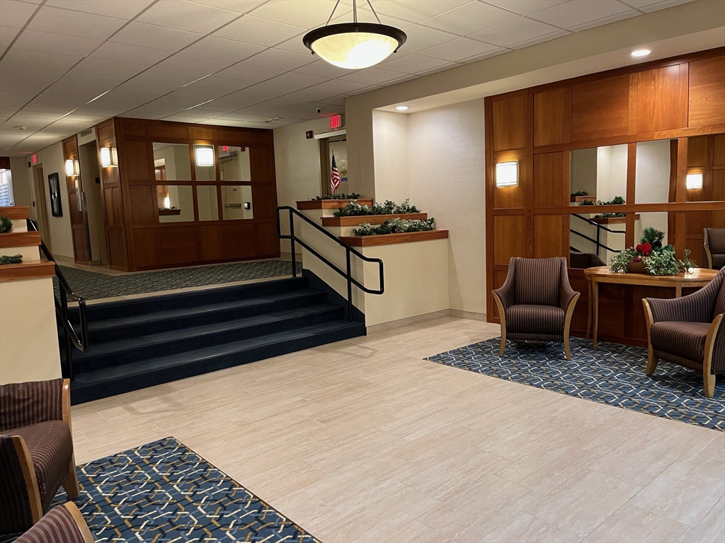 1500 Worcester Road, Unit 621 Framingham, MA 01702 - Photo 16 of 17 a living room with furniture a rug and a window