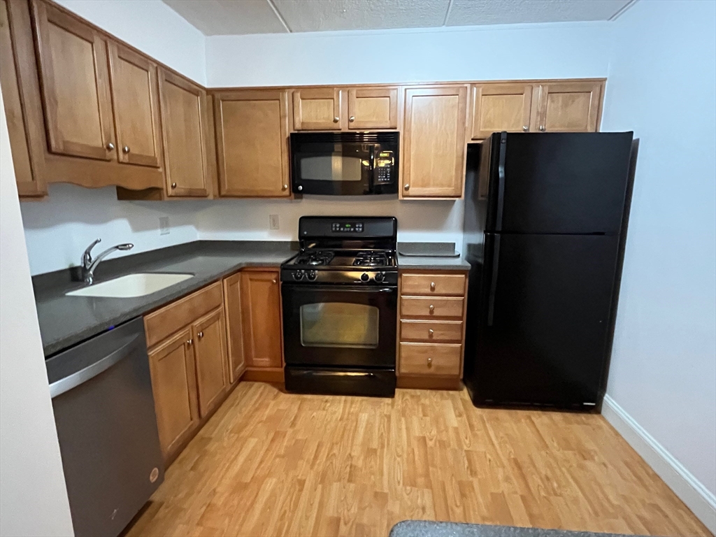 1500 Worcester Road, Unit 621 Framingham, MA 01702 - Photo 3 of 17 a kitchen with a refrigerator stove and sink
