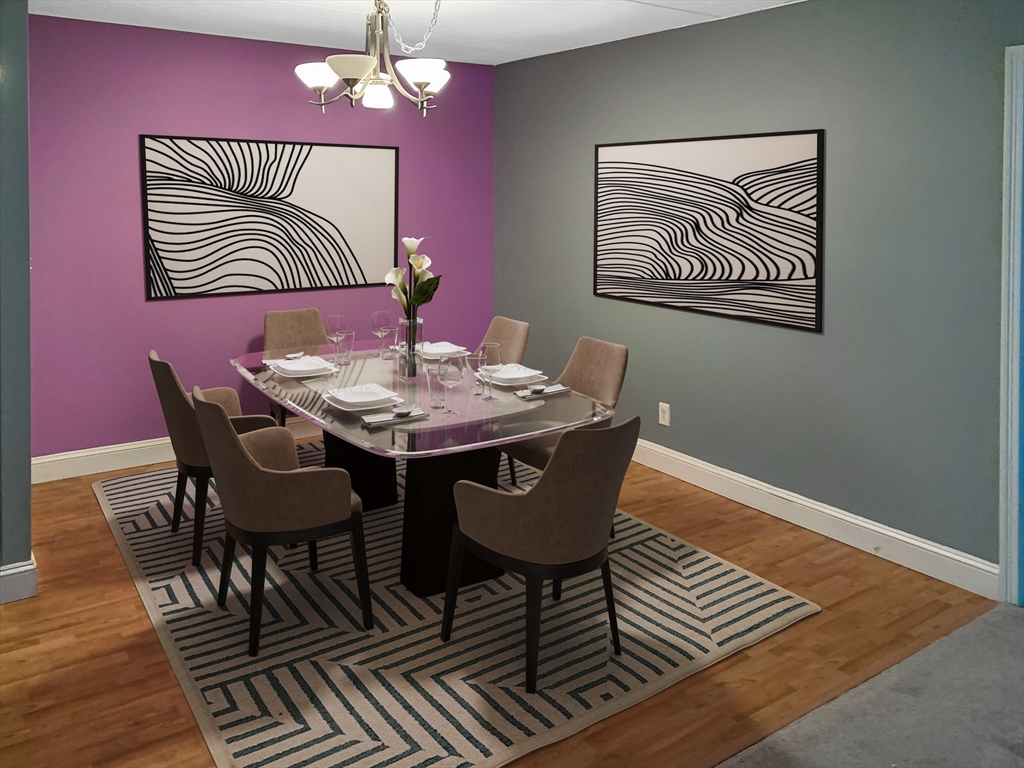 1500 Worcester Road, Unit 621 Framingham, MA 01702 - Photo 5 of 17 a view of a dining room with furniture wooden floor and a chandelier