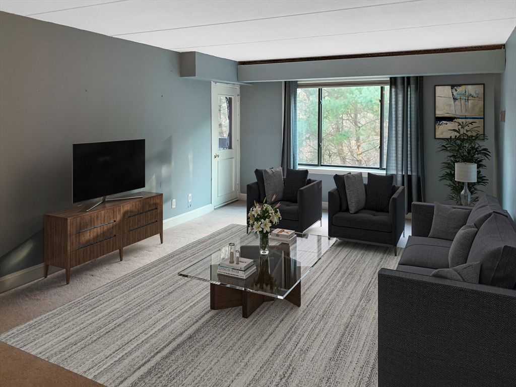 1500 Worcester Road, Unit 621 Framingham, MA 01702 - Photo 6 of 17 a living room with furniture and a flat screen tv