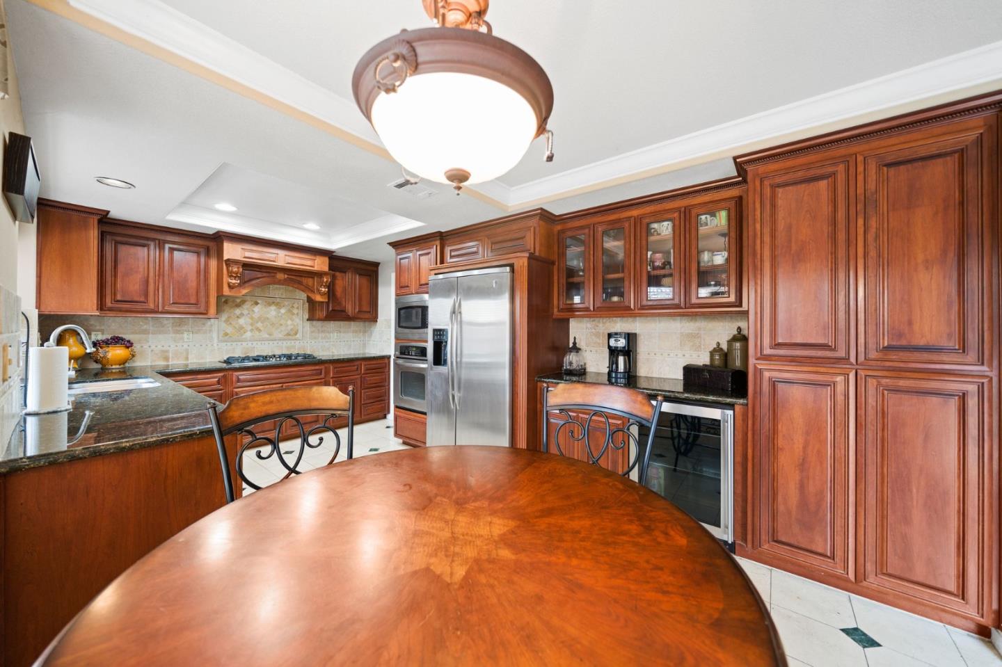1435 Eagle Street Tracy, CA 95376 - Photo 13 of 24 a open kitchen with stainless steel appliances granite countertop a stove refrigerator and cabinets