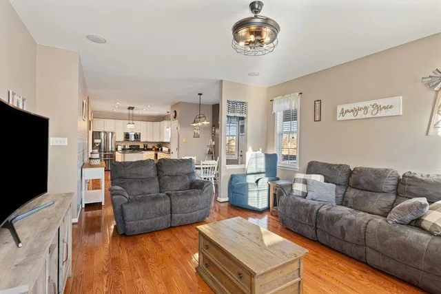 a view of a porch with furniture and wooden floor