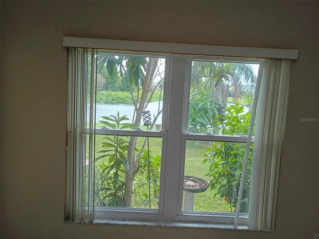 a view of room with green trees and couches