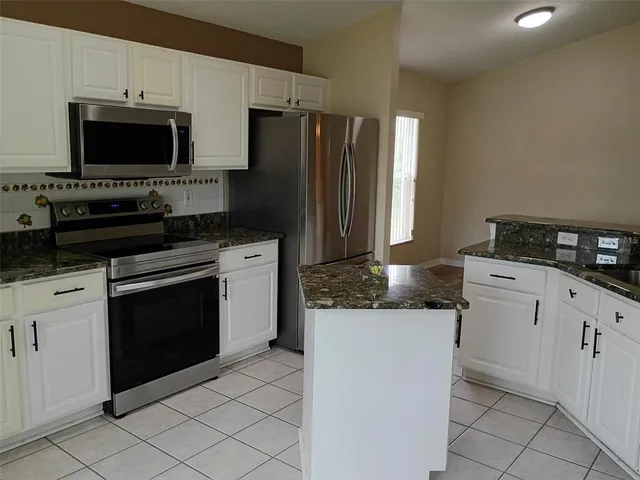 a kitchen with a stove and a refrigerator