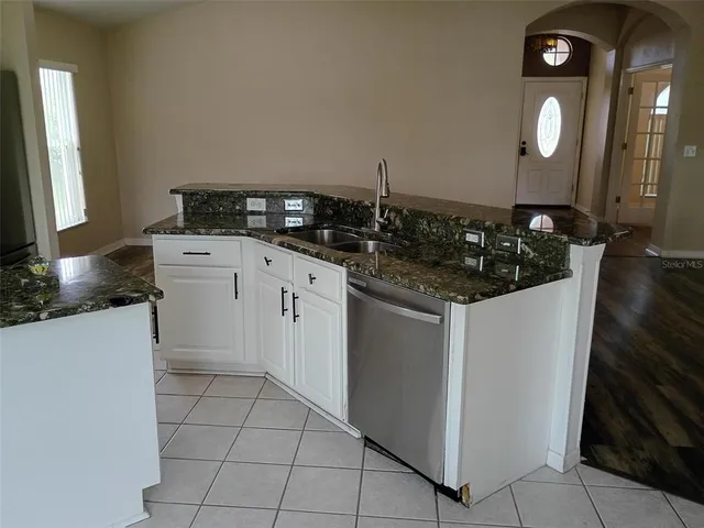 a kitchen with a sink and cabinets