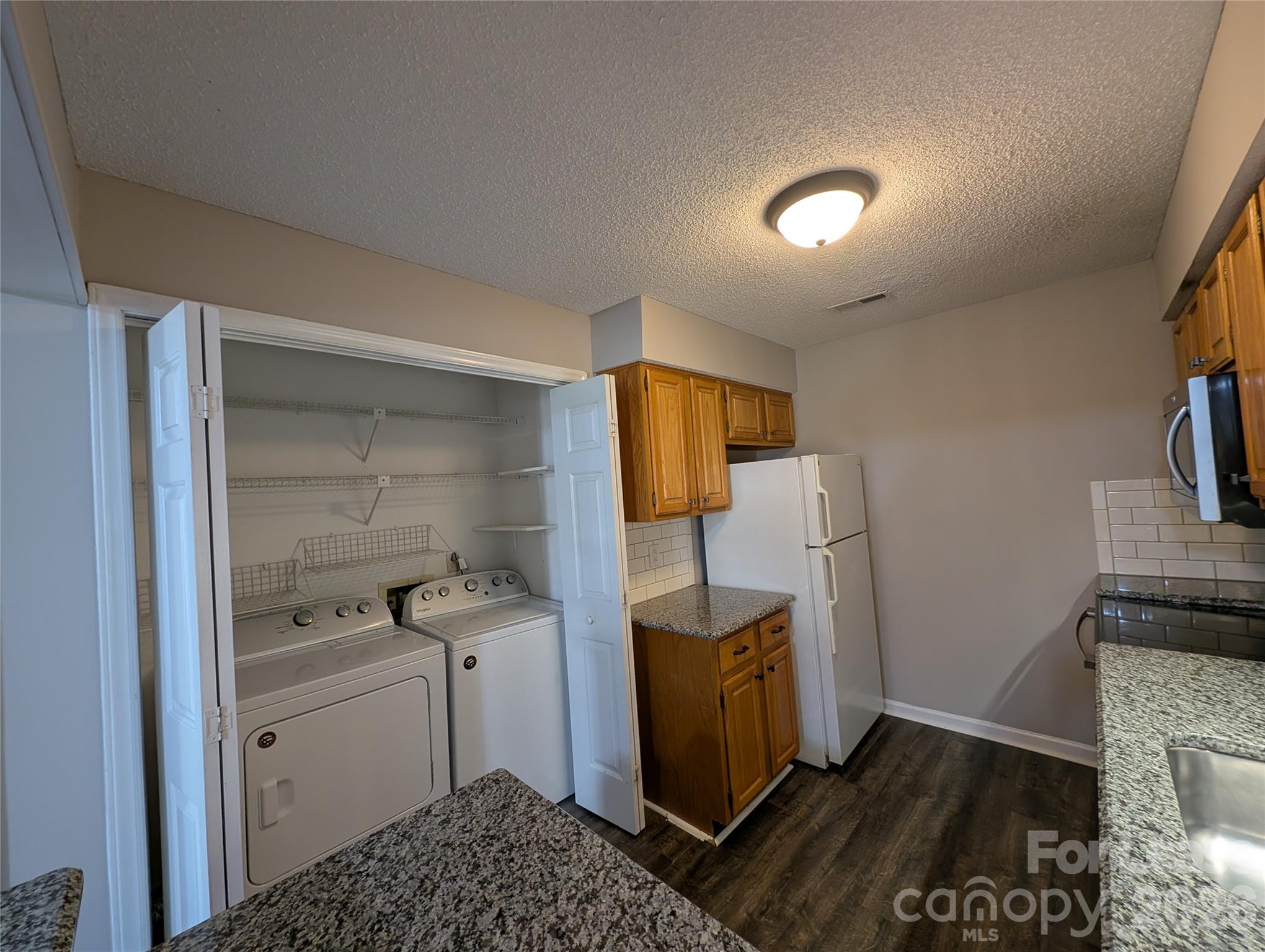 5001 Sharon Road, Unit K Charlotte, NC 28210 - Photo 4 of 24 a room with storage and utility