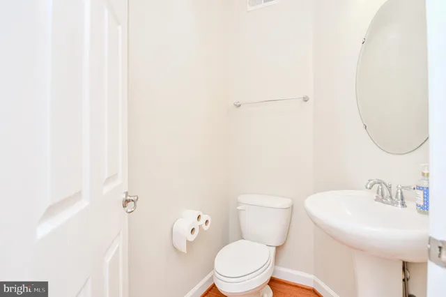 a white toilet sitting next to a bathroom sink