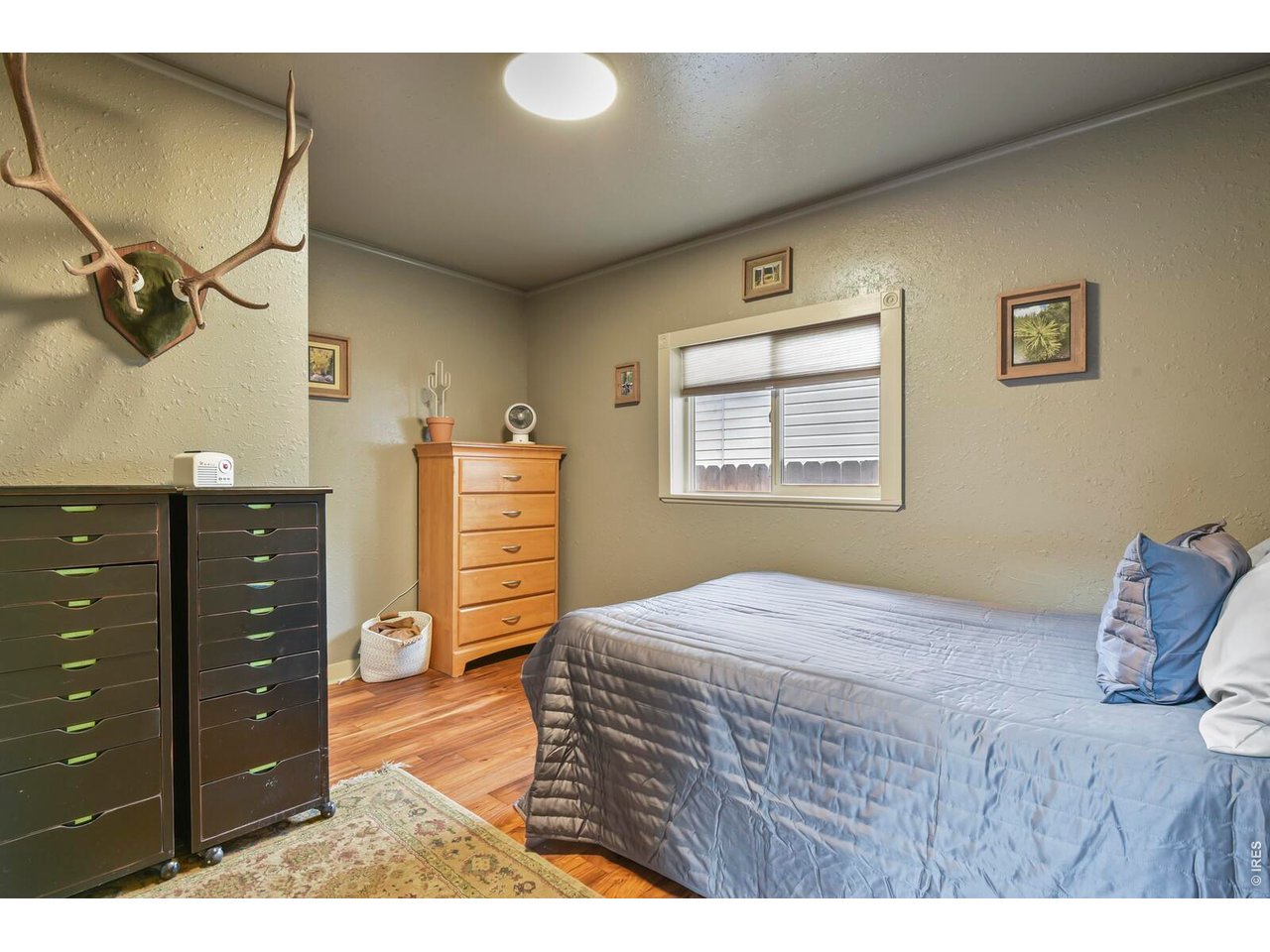 417 2nd Street Fort Lupton, CO 80621 - Photo 16 of 24 a bedroom with a bed and a dresser