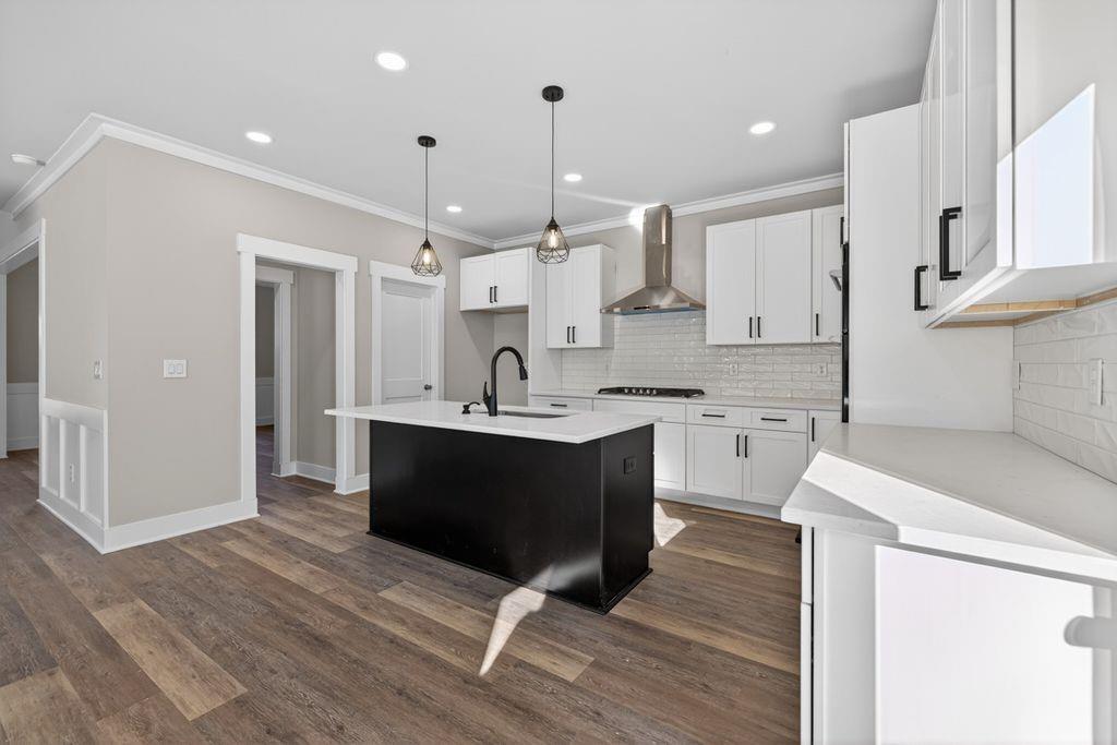 4947 Old Orr Road Flowery Branch, GA 30542 - Photo 15 of 60 a kitchen with stainless steel appliances kitchen island granite countertop a sink cabinets and wooden floor