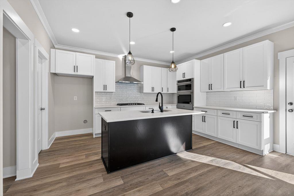 4947 Old Orr Road Flowery Branch, GA 30542 - Photo 16 of 60 a kitchen with stainless steel appliances granite countertop a sink a stove a refrigerator and white cabinets