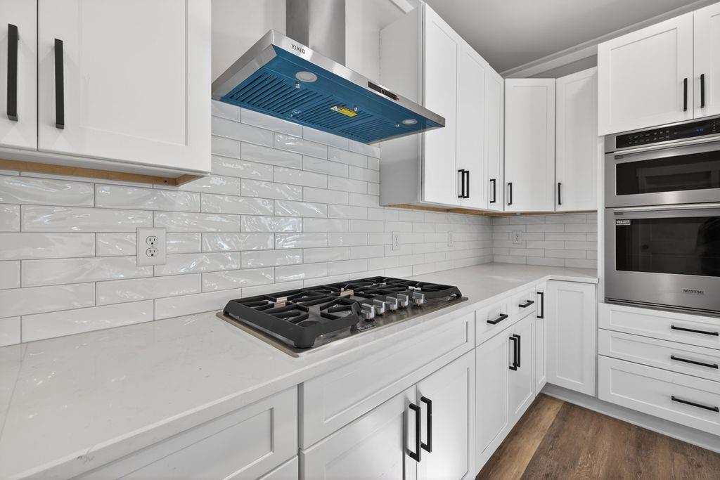 4947 Old Orr Road Flowery Branch, GA 30542 - Photo 17 of 60 a kitchen with white cabinets and appliances