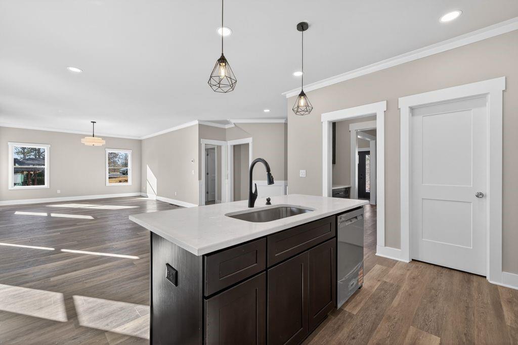 4947 Old Orr Road Flowery Branch, GA 30542 - Photo 18 of 60 a kitchen with a sink chandelier and wooden floor