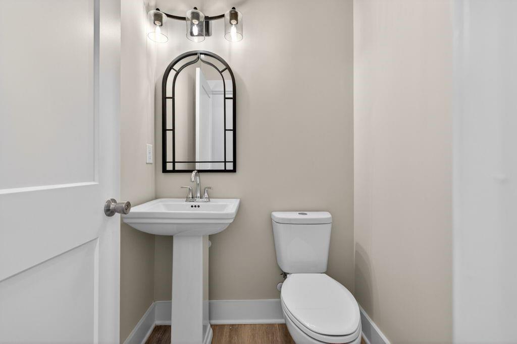 4947 Old Orr Road Flowery Branch, GA 30542 - Photo 20 of 60 a bathroom with a toilet sink and mirror