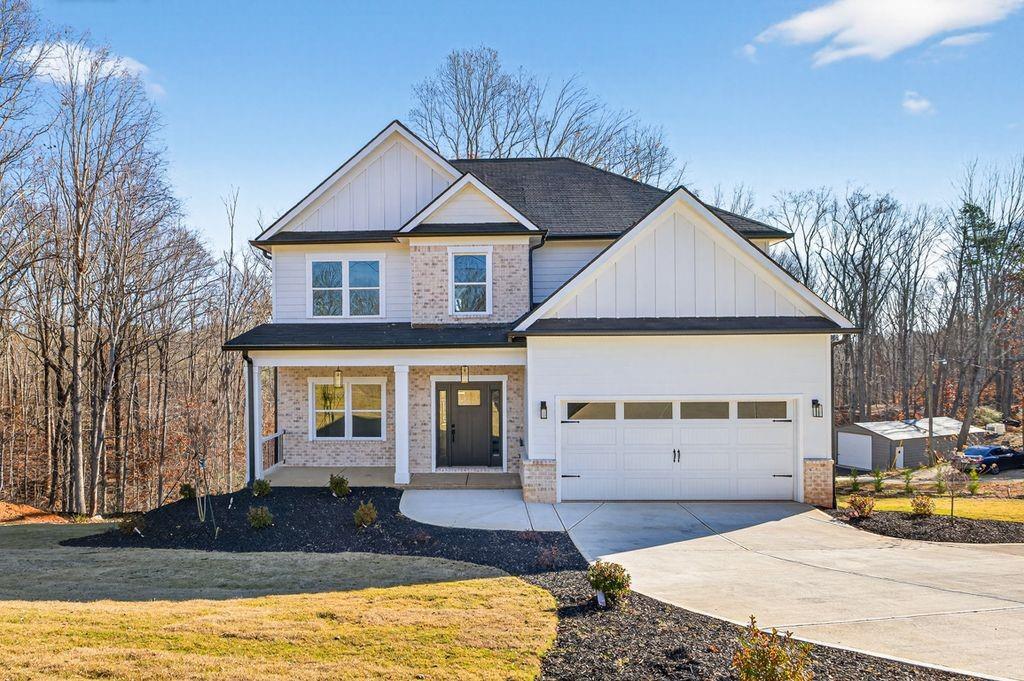 4947 Old Orr Road Flowery Branch, GA 30542 - Photo 2 of 60 a front view of a house with a yard and garage