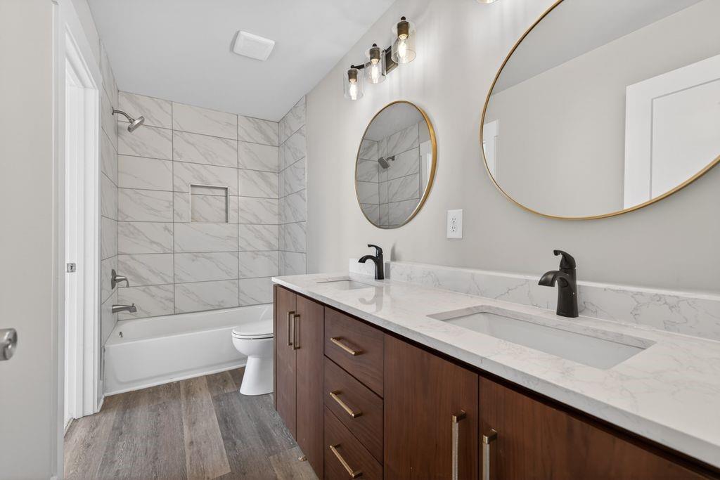 4947 Old Orr Road Flowery Branch, GA 30542 - Photo 30 of 60 a bathroom with a granite countertop sink a large mirror and bathtub